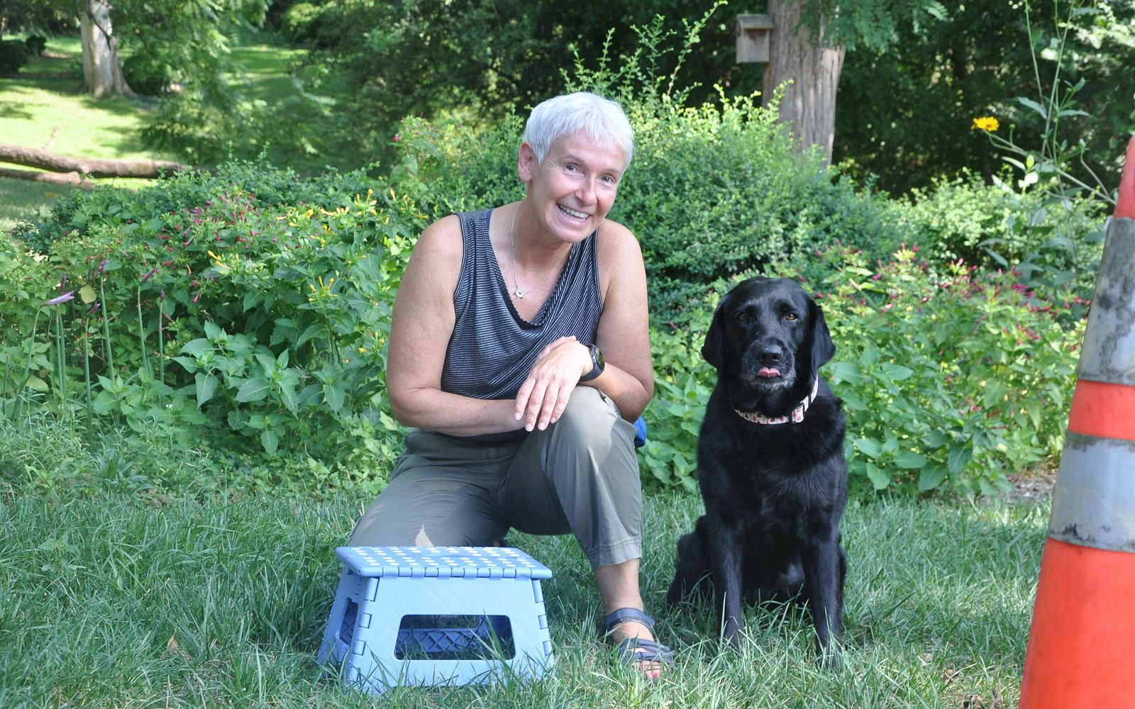 Eva Klenner with a happy black Labrador during outdoor training